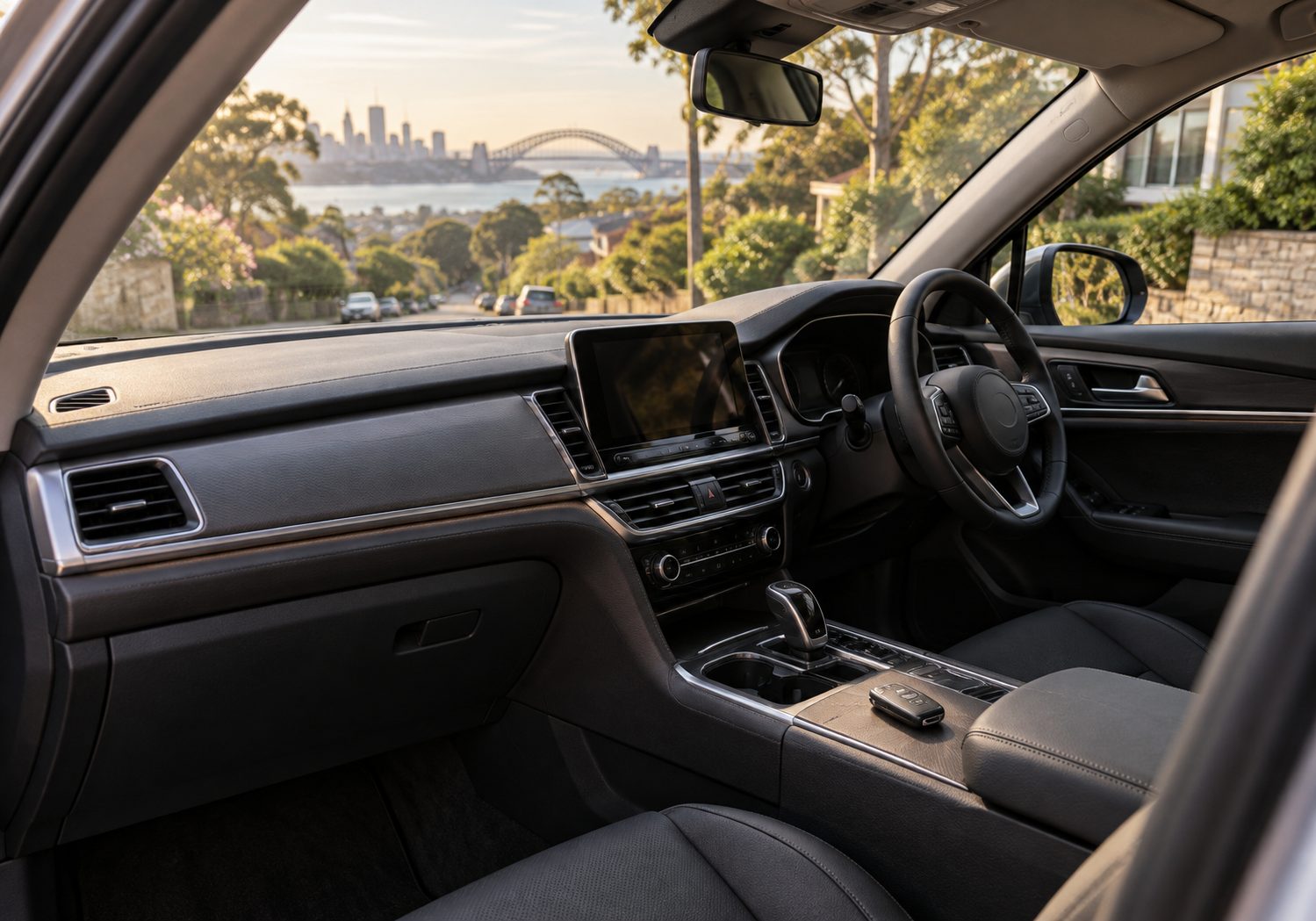Illustration of the inside of a parked car, looking across the console to the steering wheel and a suburban street beyond the windscreen.